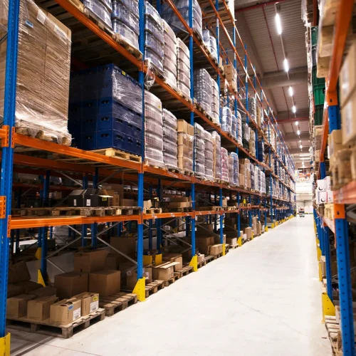 interior-large-distribution-warehouse-with-shelves-stacked-with-palettes-goods-ready-market (1)