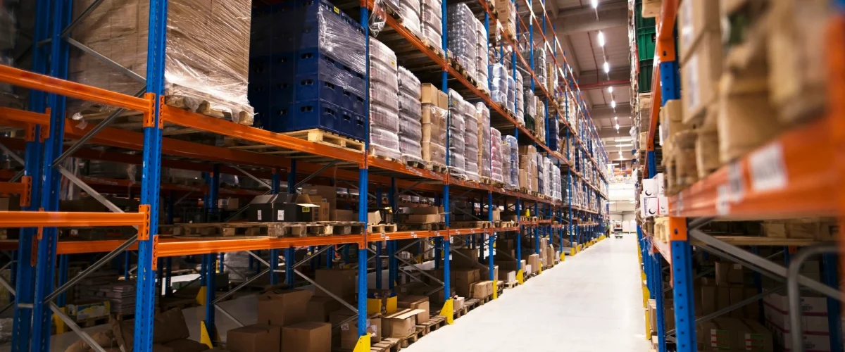 interior-large-distribution-warehouse-with-shelves-stacked-with-palettes-goods-ready-market (1)